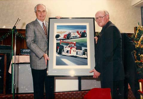 Gavin presenting Roger Penske with an original that was commissioned by Team Penske.